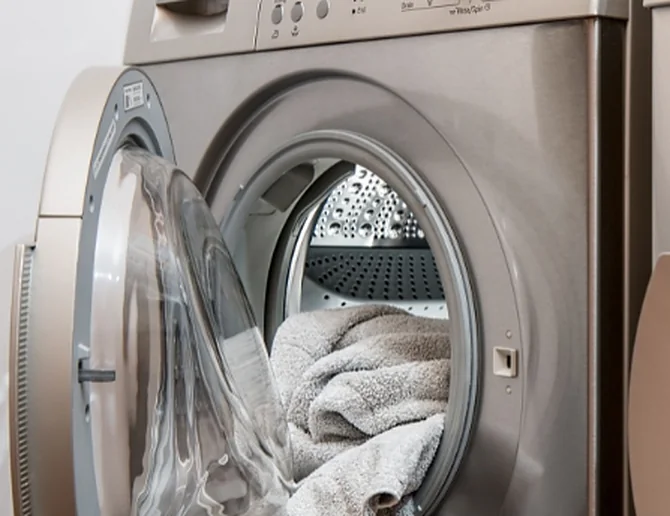 Fresh towels in the open drum of a laundry appliance