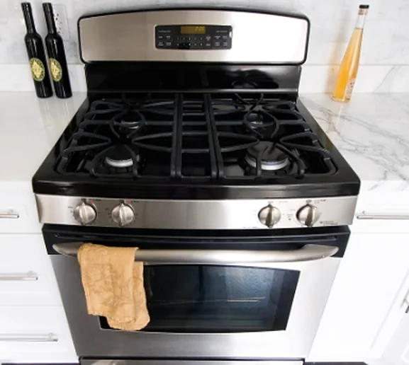 A stainless gas range in a bright kitchen